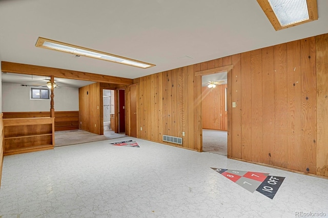 interior space with wood walls and light colored carpet