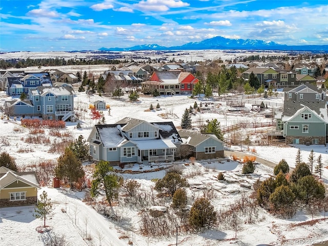 snowy aerial view with a mountain view