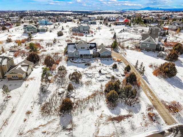 snowy aerial view featuring a residential view