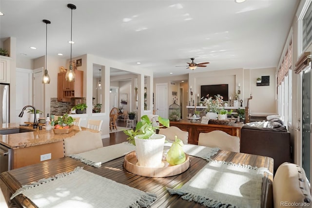 dining room featuring a ceiling fan, recessed lighting, and wood finished floors