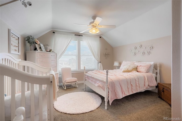 carpeted bedroom featuring baseboards, a ceiling fan, and vaulted ceiling