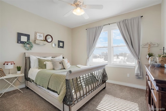 bedroom with a ceiling fan, baseboards, and carpet