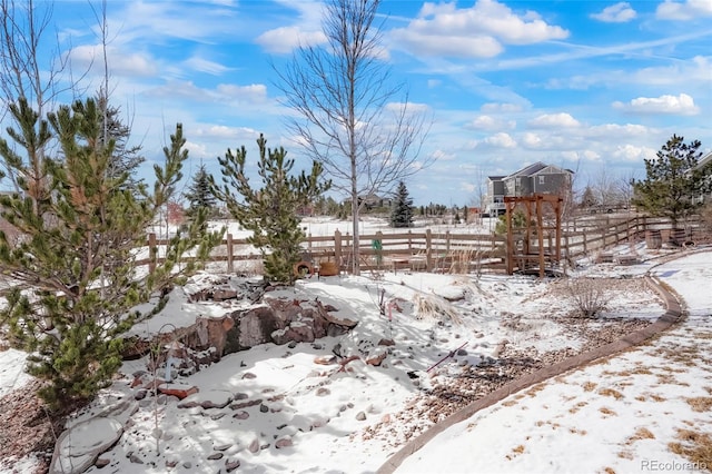snowy yard with fence