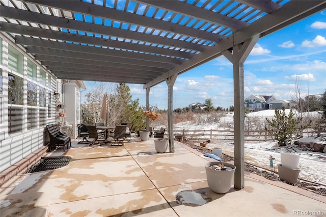 snow covered patio with a pergola, outdoor dining space, and a fenced backyard