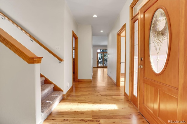 entryway featuring light wood-type flooring, stairway, baseboards, and recessed lighting