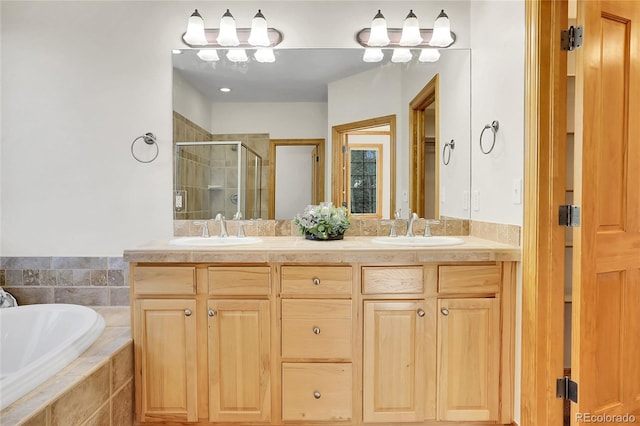 full bath featuring a stall shower, a garden tub, a sink, and double vanity