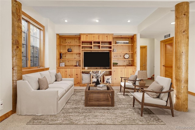 carpeted living area featuring baseboards, visible vents, and recessed lighting