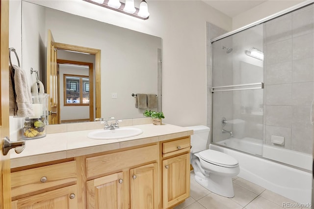 full bathroom with toilet, enclosed tub / shower combo, vanity, and tile patterned floors