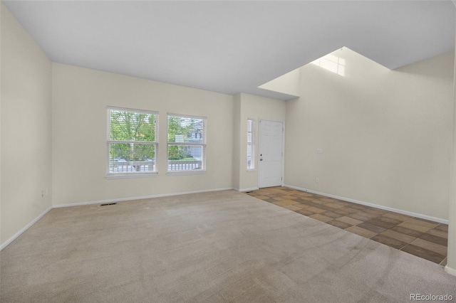 unfurnished room featuring light carpet