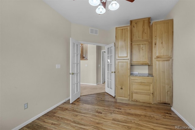 interior space featuring french doors, light brown cabinets, light hardwood / wood-style flooring, and ceiling fan