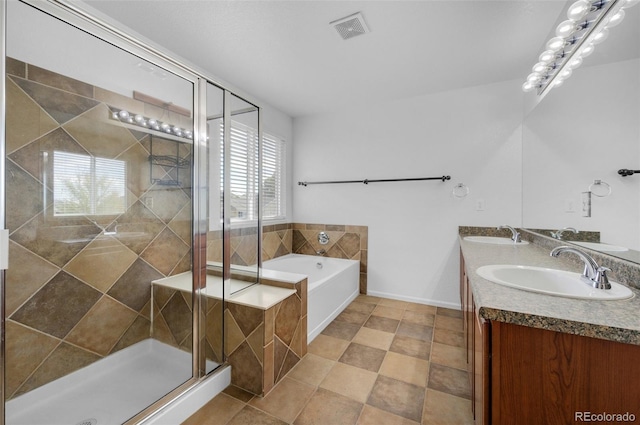 bathroom with vanity and independent shower and bath