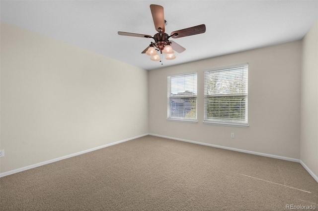 spare room featuring carpet flooring and ceiling fan