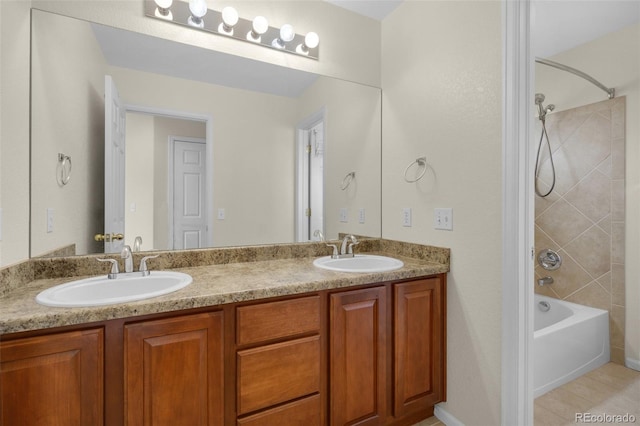 bathroom with tile patterned flooring, vanity, and tiled shower / bath combo