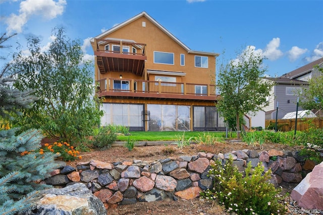 rear view of property featuring a balcony