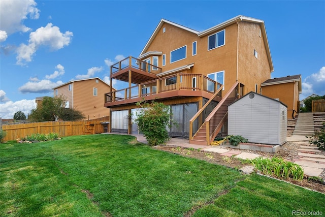 back of house featuring a lawn, a storage unit, and a wooden deck