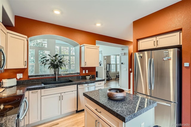 8300 Fairmount Dr Unit Aa102, Denver, CO 80247 - kitchen with appliances with stainless steel finishes, a sink, plenty of natural light, light wood finished floors, and recessed lighting