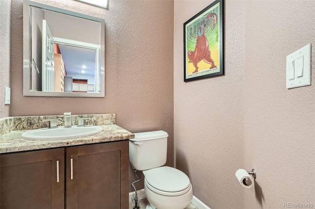 8300 Fairmount Dr Unit Aa102, Denver, CO 80247 - half bath featuring vanity, toilet, and a textured wall