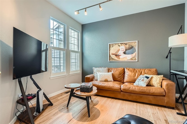8300 Fairmount Dr Unit Aa102, Denver, CO 80247 - living area with rail lighting, wood finished floors, and baseboards