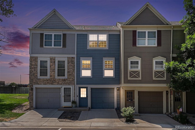 8259 S Fillmore Cir, Centennial, CO 80122 - multi unit property with an attached garage, driveway, and stone siding