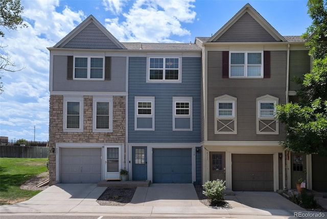 8259 S Fillmore Cir, Centennial, CO 80122 - townhome / multi-family property with an attached garage, driveway, and stone siding