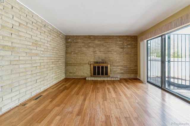 unfurnished living room with a fireplace and wood finished floors