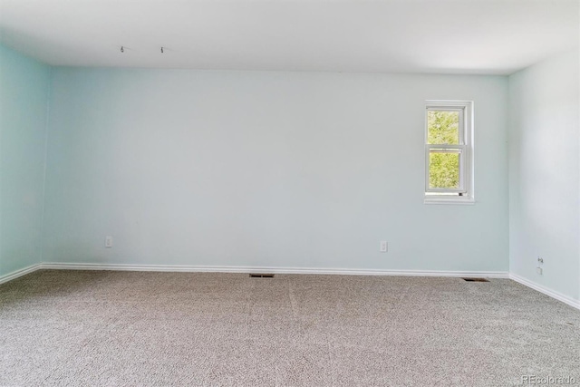 carpeted empty room with baseboards