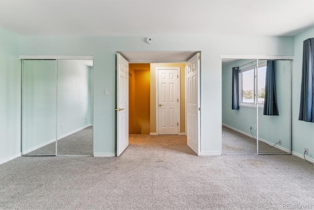 unfurnished bedroom featuring carpet, baseboards, and a closet
