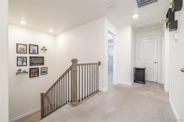 hall with light colored carpet