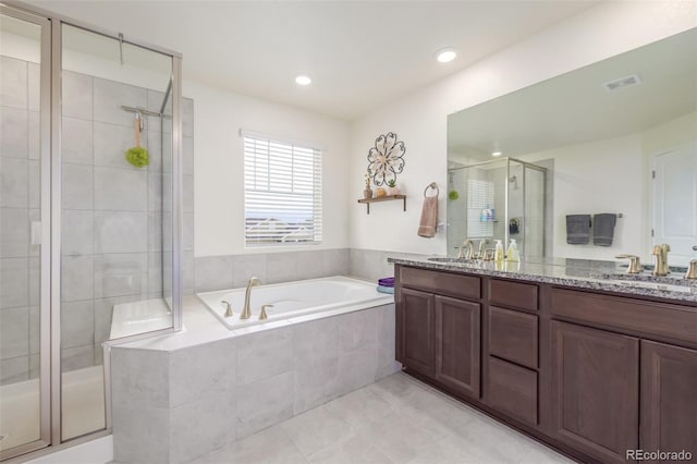 bathroom featuring vanity, plus walk in shower, and tile patterned floors