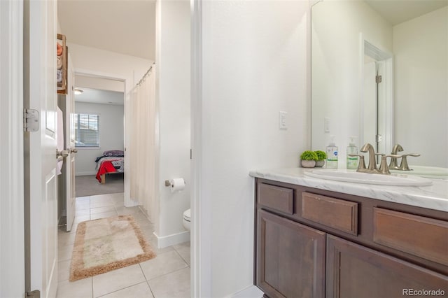 bathroom with vanity, toilet, and tile patterned flooring