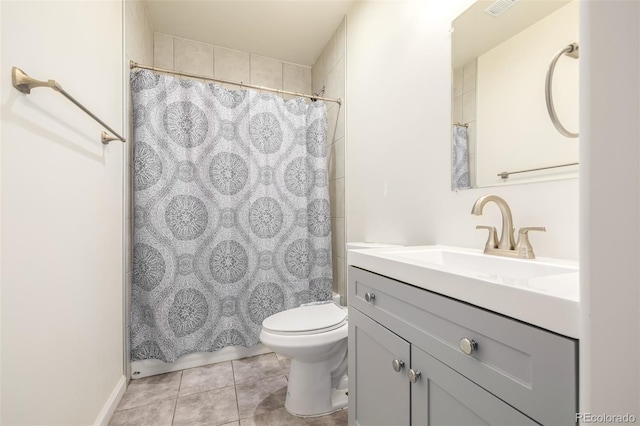 bathroom with vanity, curtained shower, toilet, and tile patterned flooring