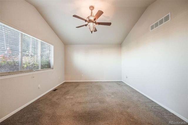 carpeted spare room with ceiling fan and vaulted ceiling