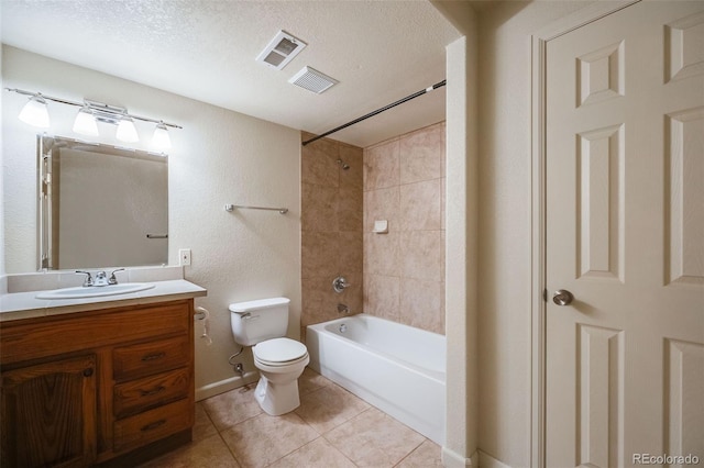 full bathroom with toilet, a textured ceiling, vanity, tiled shower / bath combo, and tile patterned flooring