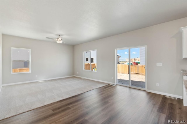 7303 Dolores Ave, Frederick, CO 80530 - unfurnished living room with a ceiling fan, wood finished floors, and baseboards