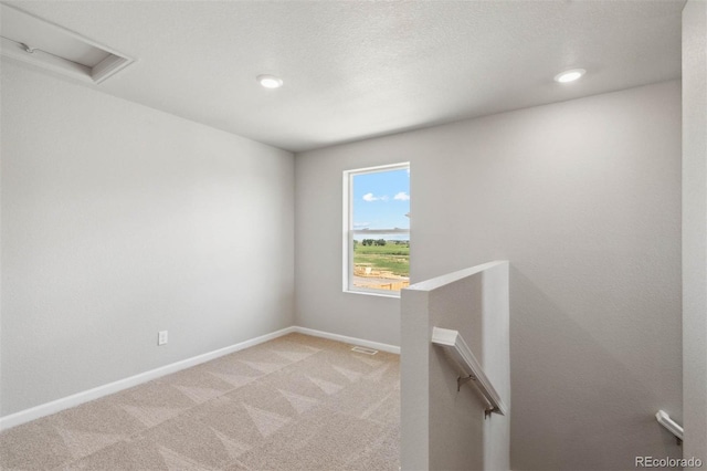 7303 Dolores Ave, Frederick, CO 80530 - unfurnished room with attic access, light colored carpet, baseboards, and recessed lighting