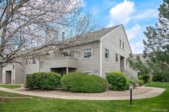 3600 S Pierce St Unit 1-207, Denver, CO 80235 - view of property exterior featuring a chimney and a lawn