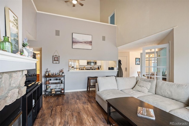 3600 S Pierce St Unit 1-207, Denver, CO 80235 - living room with a high ceiling, ceiling fan, dark wood finished floors, and baseboards