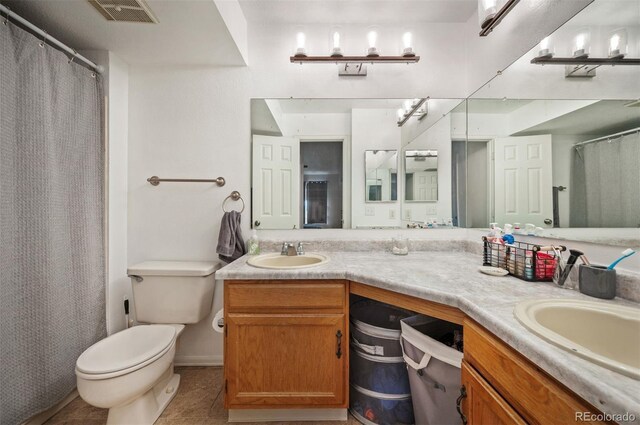 3600 S Pierce St Unit 1-207, Denver, CO 80235 - bathroom featuring double vanity, toilet, and tile patterned floors