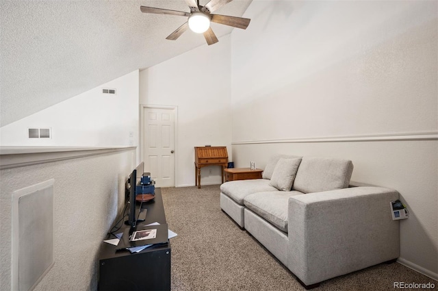 3600 S Pierce St Unit 1-207, Denver, CO 80235 - carpeted living room with vaulted ceiling, ceiling fan, baseboards, and a textured ceiling