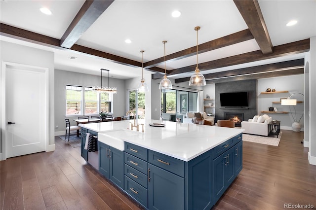 4868 Hogback Ridge Rd, Morrison, CO 80465 - kitchen featuring blue cabinetry, a sink, baseboards, dark wood-type flooring, and beamed ceiling