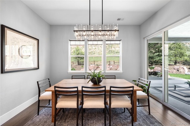 4868 Hogback Ridge Rd, Morrison, CO 80465 - dining space featuring dark wood-type flooring, a chandelier, and baseboards