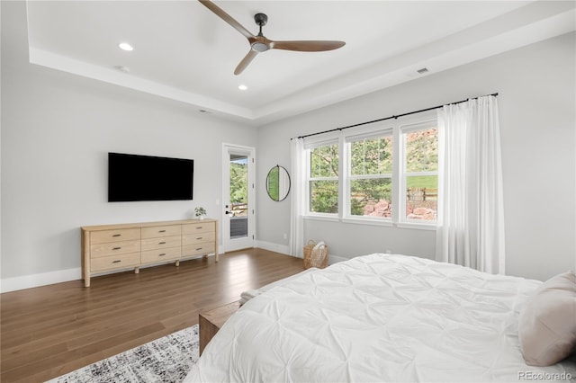4868 Hogback Ridge Rd, Morrison, CO 80465 - bedroom featuring access to outside, wood finished floors, a raised ceiling, recessed lighting, and baseboards