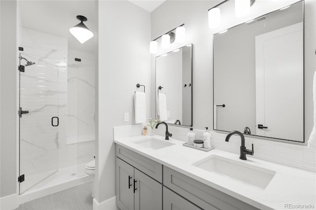 4868 Hogback Ridge Rd, Morrison, CO 80465 - full bathroom featuring toilet, a marble finish shower, decorative backsplash, and double vanity