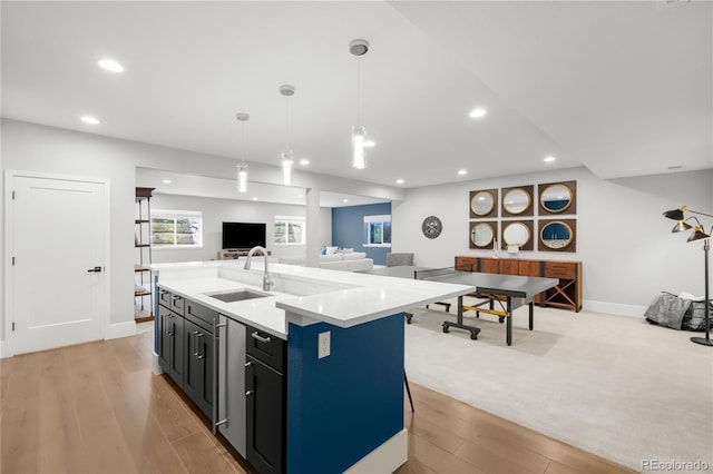 4868 Hogback Ridge Rd, Morrison, CO 80465 - kitchen with a sink, open floor plan, light wood-style floors, recessed lighting, and pendant lighting