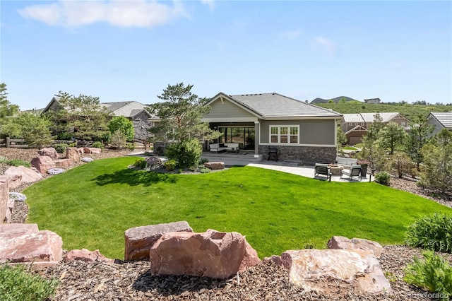4868 Hogback Ridge Rd, Morrison, CO 80465 - back of property with a patio, an outdoor living space, stone siding, and a lawn