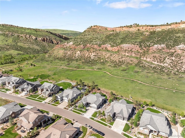 4868 Hogback Ridge Rd, Morrison, CO 80465 - aerial view of property's location with nearby suburban area and a mountain backdrop