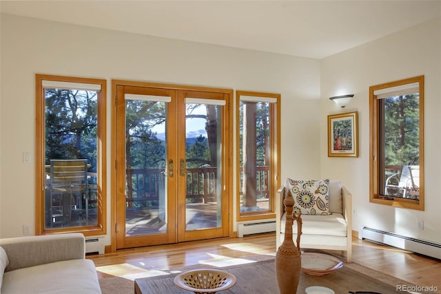 entryway featuring french doors, a wealth of natural light, and a baseboard heating unit