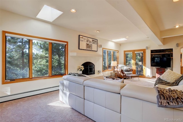 living room featuring french doors, a baseboard heating unit, carpet floors, a skylight, and beamed ceiling