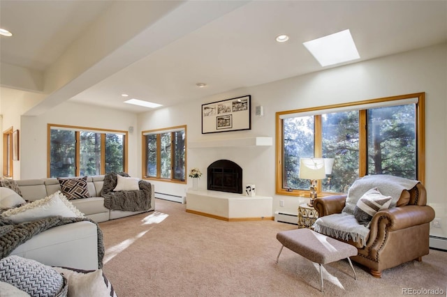 living room featuring baseboard heating, a skylight, and carpet flooring