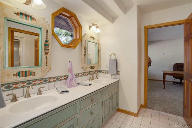 bathroom with vanity, tile patterned flooring, and backsplash